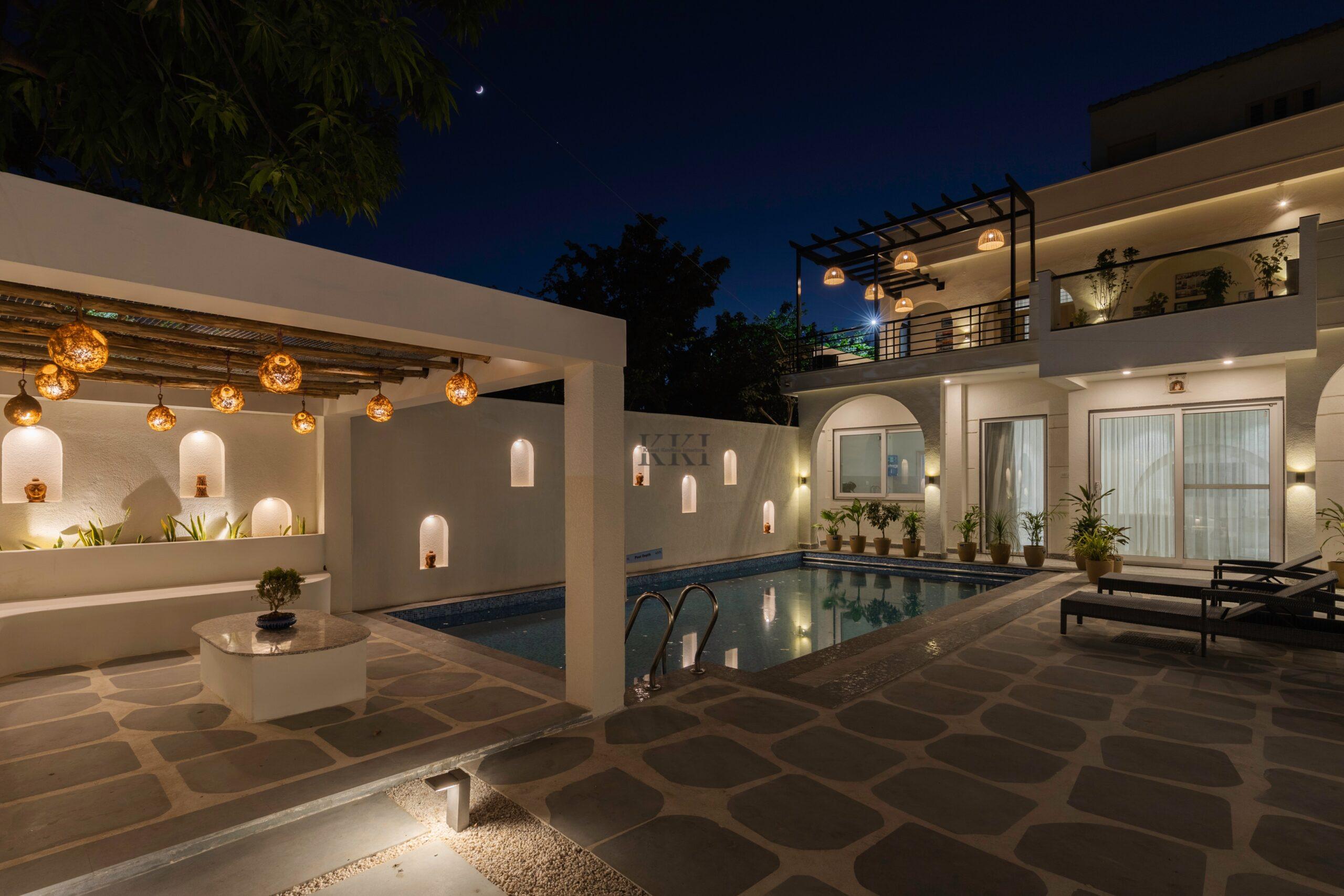 Swimming pool and pergola area for the villa interior design by Kamal Kavita Interiors